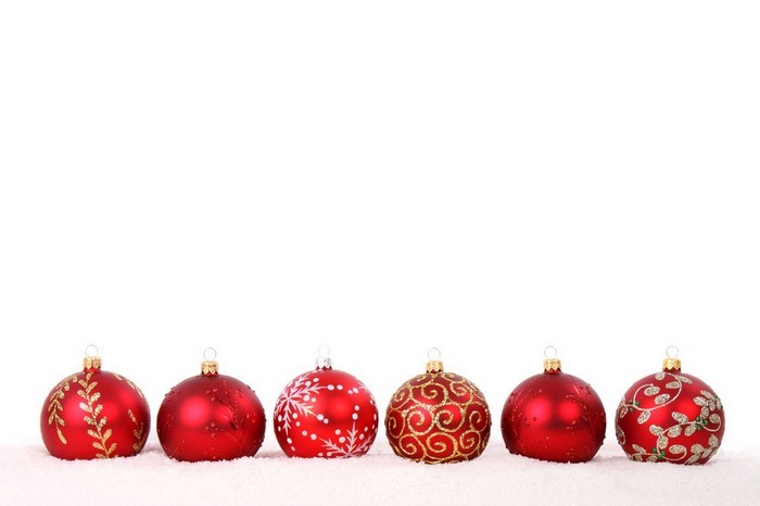 Red Christmas ornaments on snow
