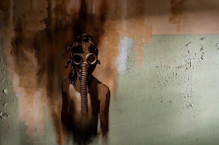 Artwork of a person wearing a gas mask on a wall