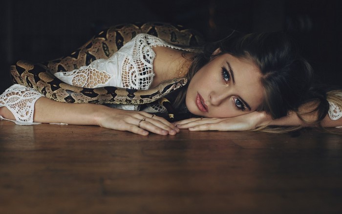 Woman with a snake on the floor