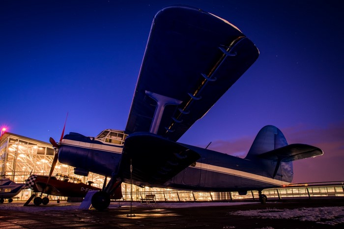 Blue Antonov airplane at night with stars
