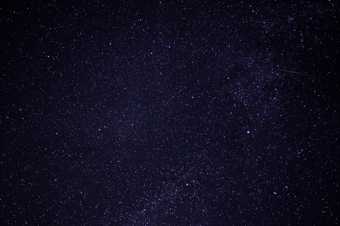 Starry night sky with a meteor shower