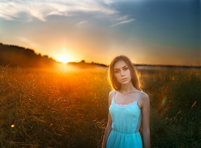 Woman in a field at sunset
