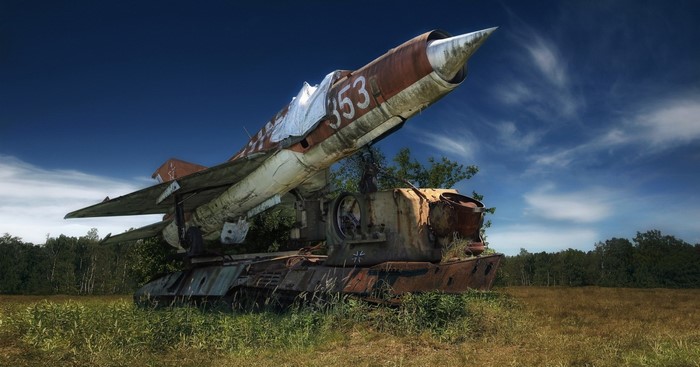 Abandoned MiG-21 fighter jet on a rusty tank chassis