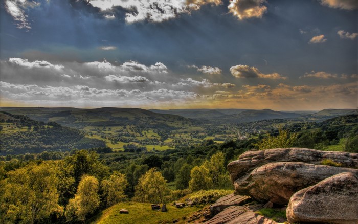 Scenic valley with rolling hills and dramatic clouds