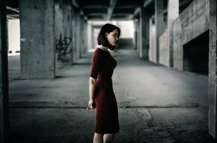 Woman in a red dress in an abandoned building