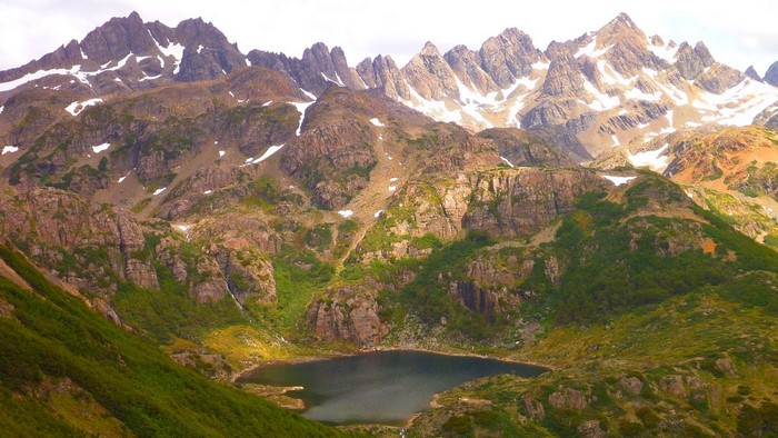 Jagged mountain range overlooking a dark lake in Patagonia