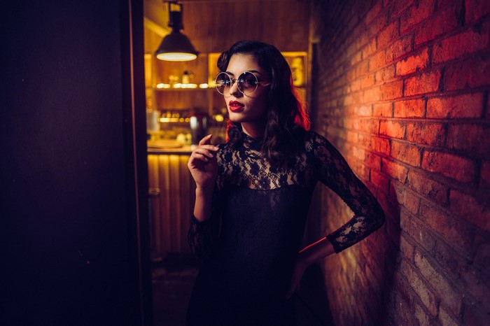 Woman in black lace dress and sunglasses