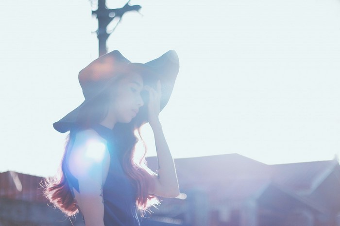 Woman in a hat with lens flare