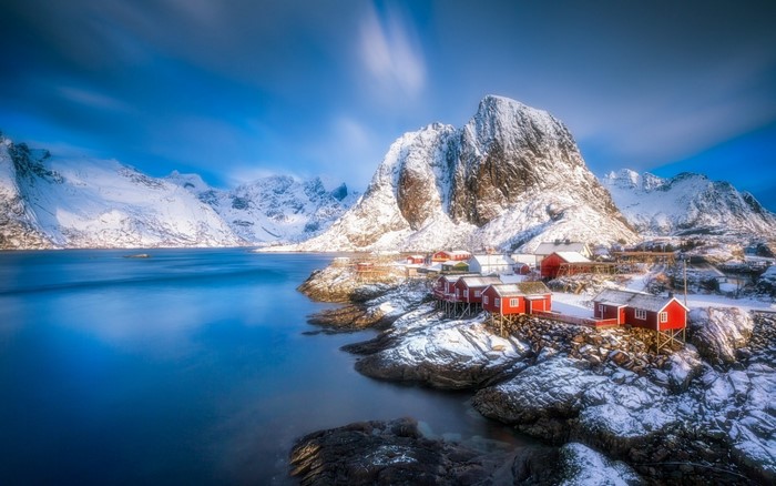 Snowy Lofoten Islands village with mountains and sea