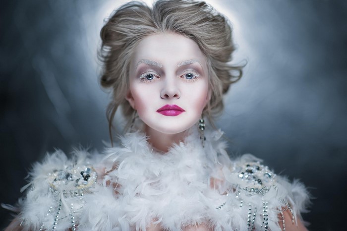 Woman with winter makeup and feather boa