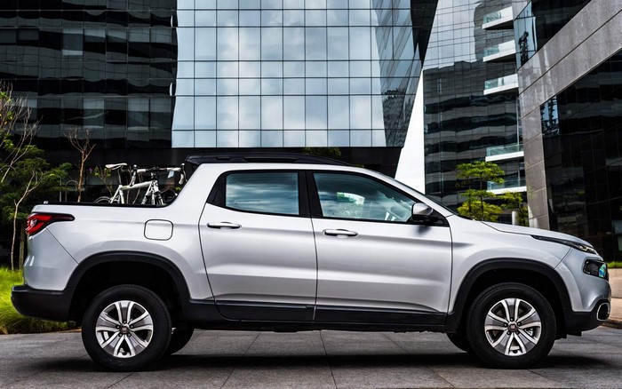 Silver Fiat pickup truck with bicycles in the bed