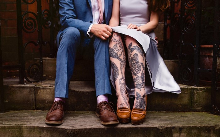 Couple with Tattoos Sitting on Steps
