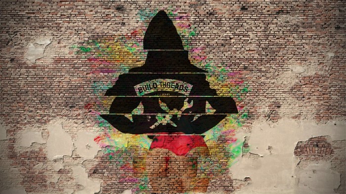 Silhouette of a person with "BUILD THREADS APPAREL" logo on a brick wall