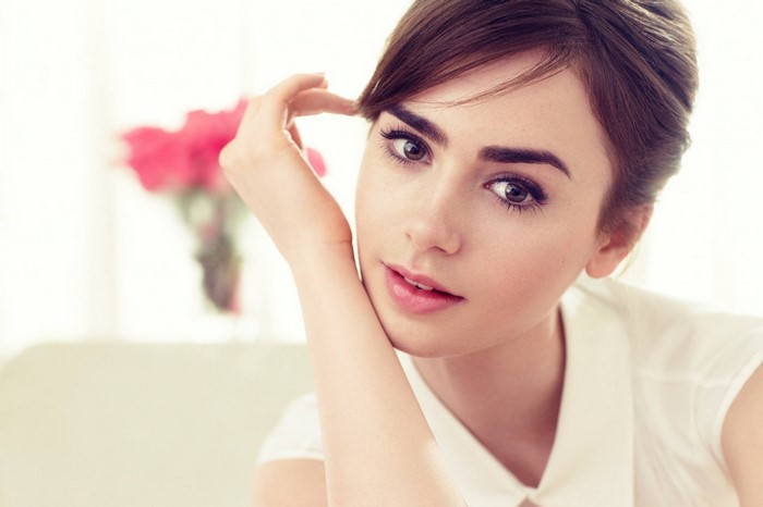Lily Collins portrait with hand on face