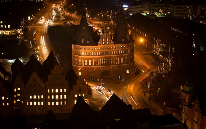 Holsten Gate and city at night with light trails