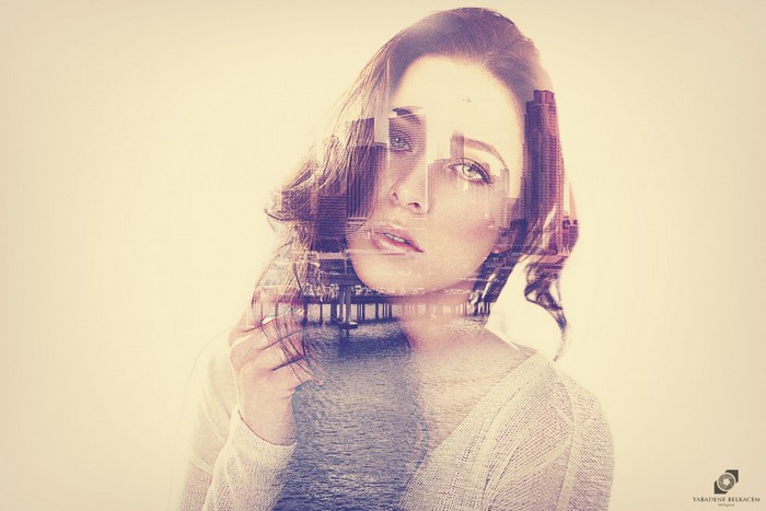 Double exposure portrait of a woman with a city skyline