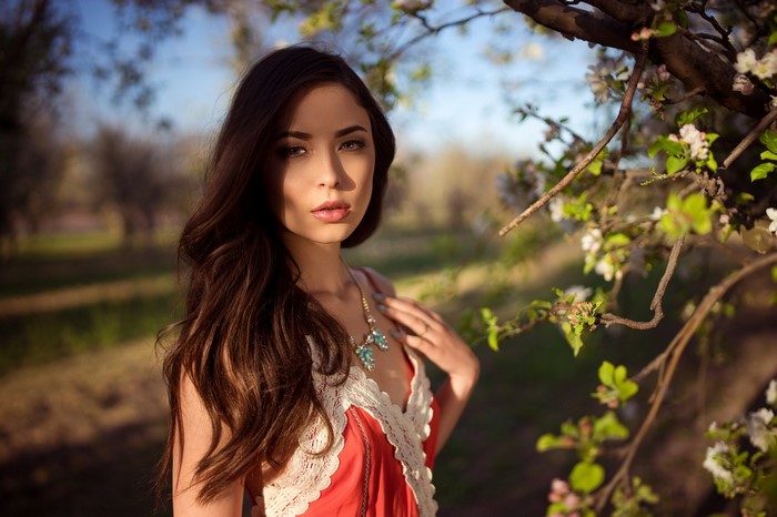 Woman in red dress with lace trim and necklace