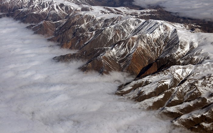 Snow-capped mountains above clouds