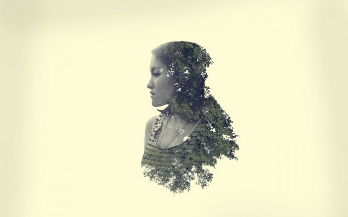 Double exposure portrait of a woman with trees