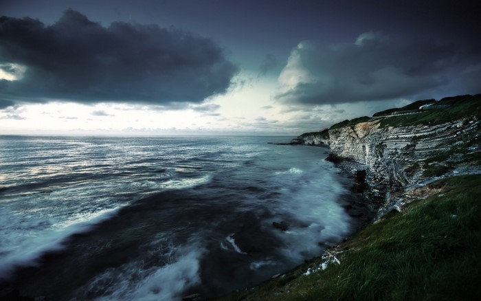 Stormy sea and cliffs at dusk
