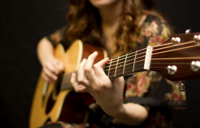 Woman playing an acoustic guitar