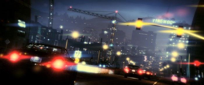 Night city street with cars and Vinewood sign