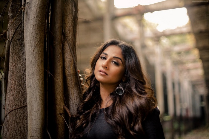 Vidya Balan posing near a tree