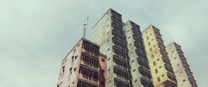 Apartment buildings with antennas against a cloudy sky