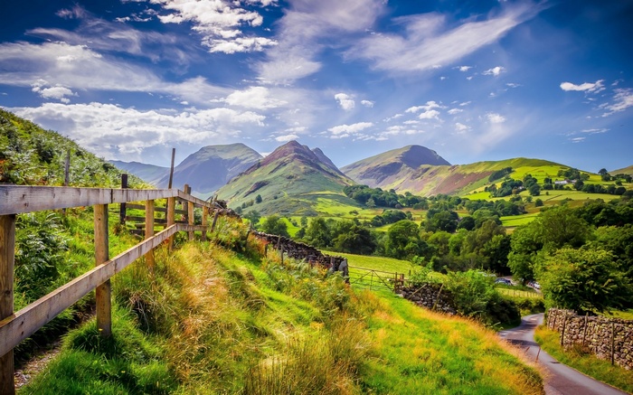 Green hills and mountains with a wooden fence