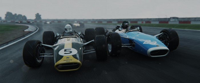 Two vintage Formula 1 cars racing on a wet track