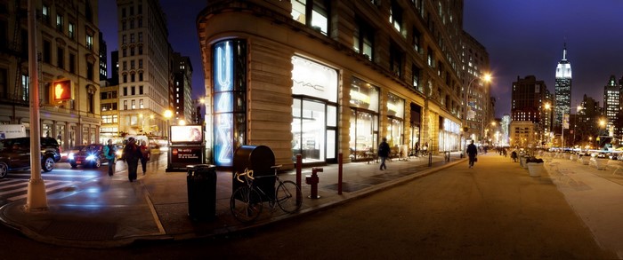 New York City street at night with MAC store and Empire State Building