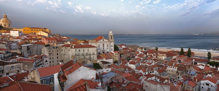 Lisbon cityscape with river and rooftops panorama