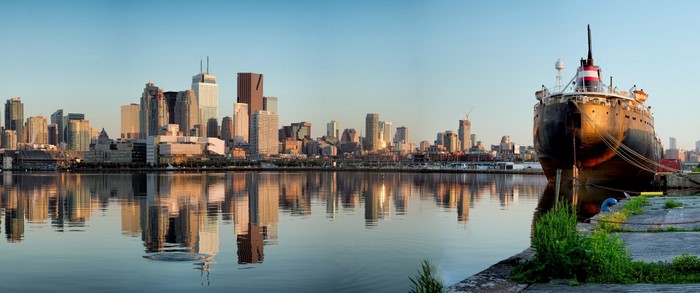 Cityscape with ship and reflections at dusk