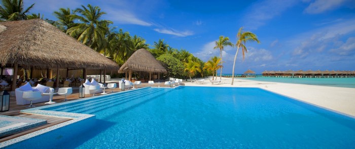 Tropical resort with infinity pool and overwater bungalows
