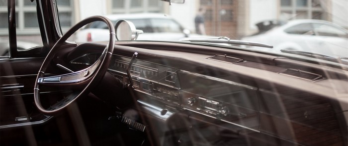 Interior of a vintage car dashboard and steering wheel