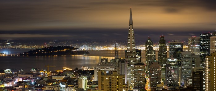 San Francisco cityscape at night with Transamerica Pyramid and Bay Bridge