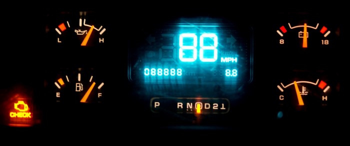 Car dashboard with digital speedometer and gauges