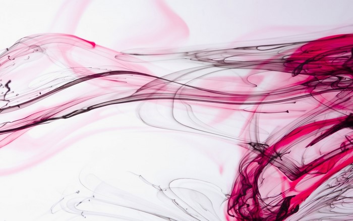 Pink and black ink swirling in water