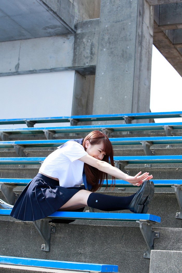 Ishida Ayumi from Morning Musume stretching on bleachers