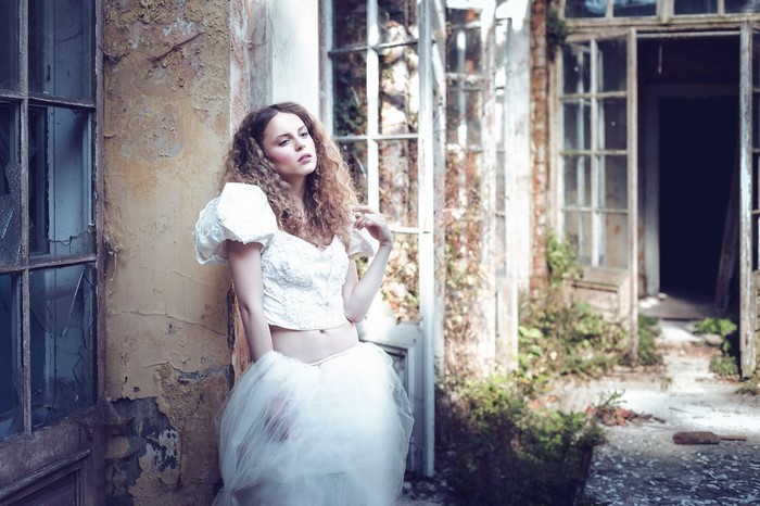Woman in white dress in abandoned building