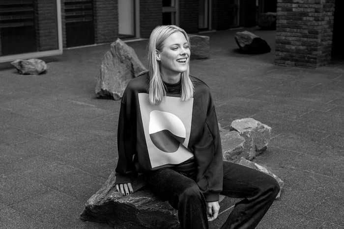 Woman sitting on rock outdoors
