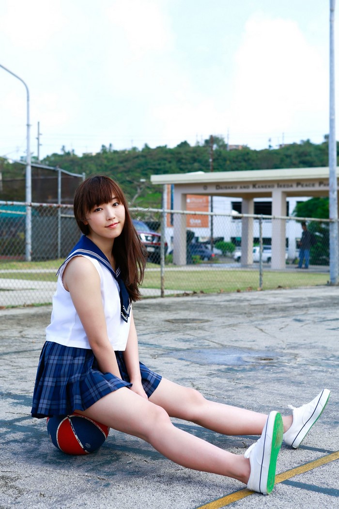 Mizuki Fukumura from Morning Musume sitting on a basketball