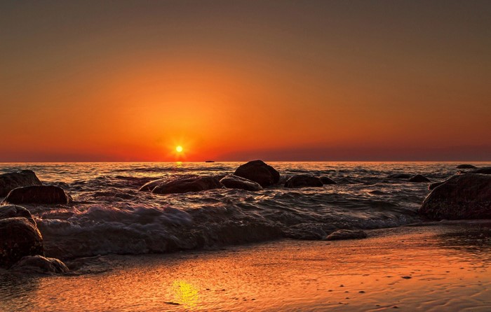 Sunset Over Rocky Seashore with Gentle Waves
