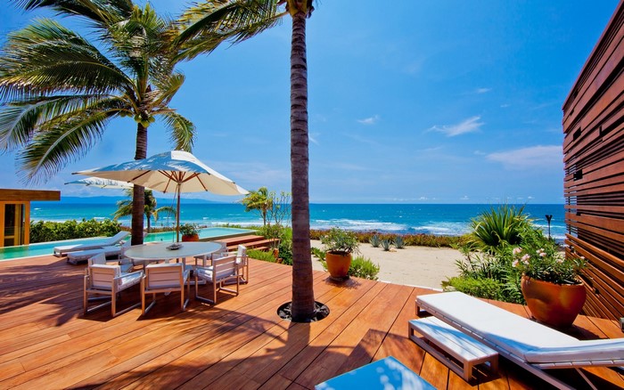 Tropical beachfront villa with swimming pool and outdoor dining area