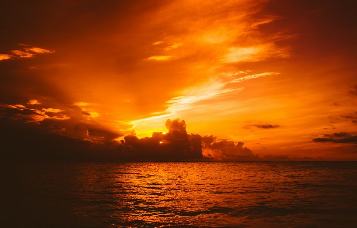Sunset over the ocean with dramatic clouds