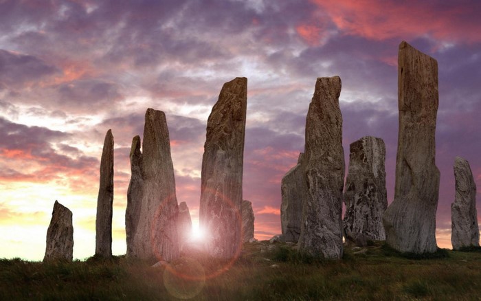 Standing stones at sunset with dramatic sky