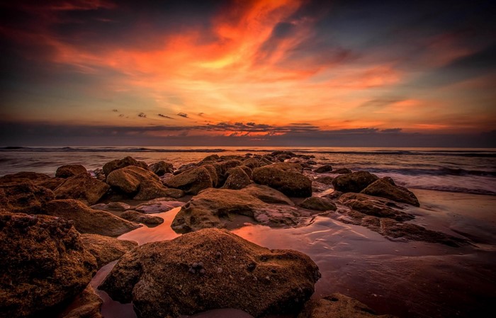Sunset Over Rocky Shore with Ocean Waves