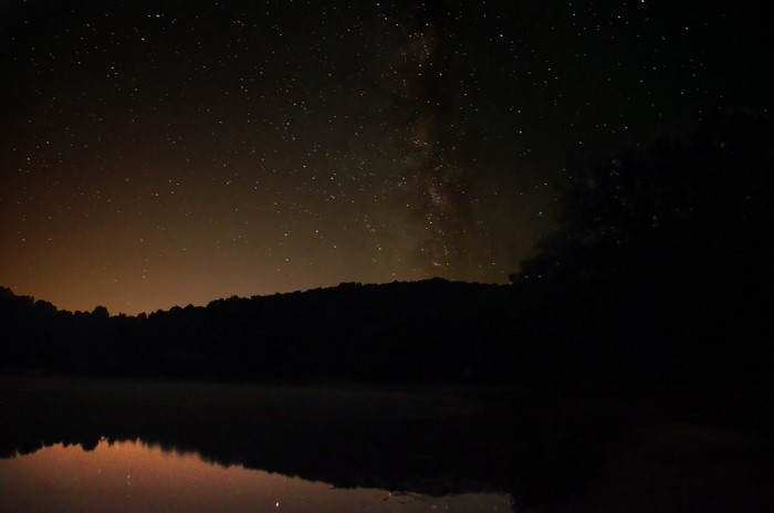 Night sky with stars and Milky Way over a lake