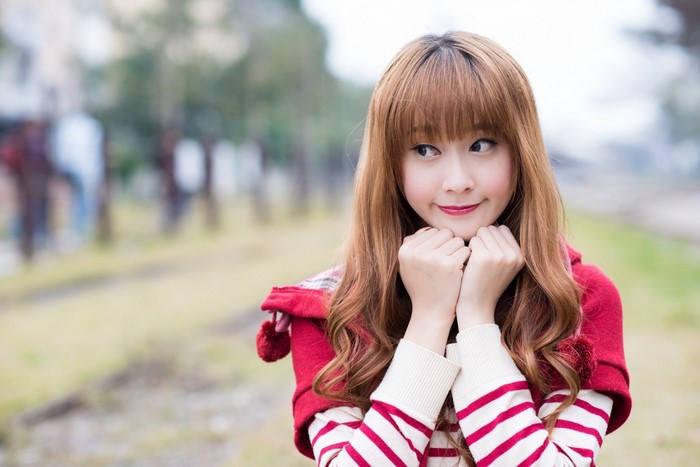 Young Asian woman with bangs and red shawl