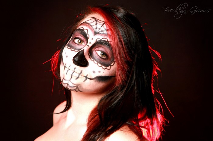 Woman with Sugar Skull makeup and red streaks in hair